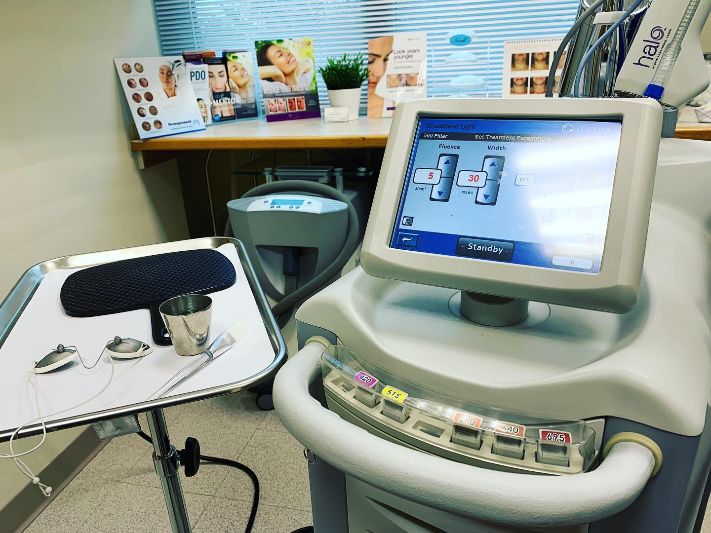 Broad Band Light Therapy device with control monitor showing treatment parameters in a clinical treatment room